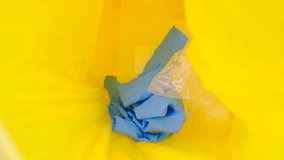 Used surgical or medical glove in garbage