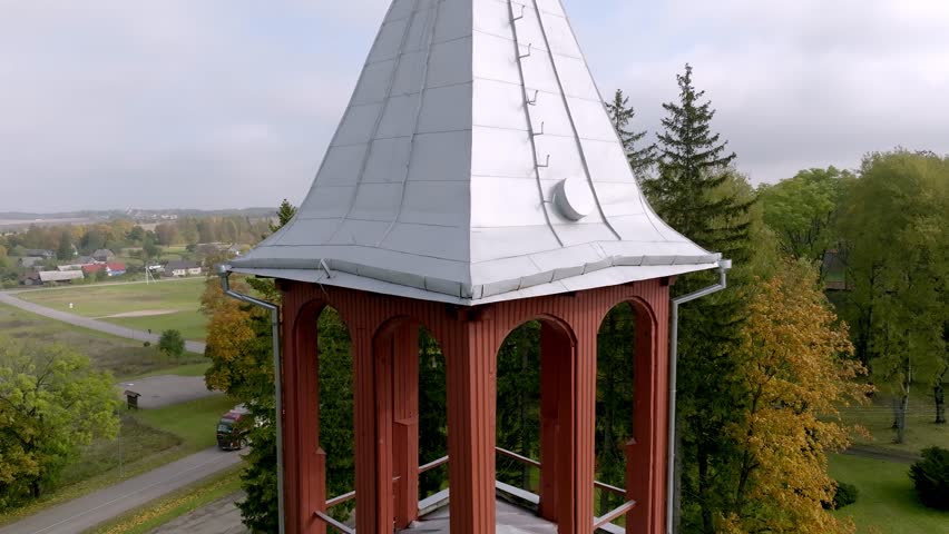 The steeple and cross of the Church of the Holy Trinity and St. Casimir in the rural Medininkai, Lithuania