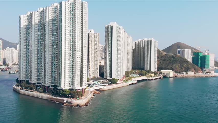 A drone shot of the urban skyscrapers and buildings by Pearl River Delta, Hong Kong, China