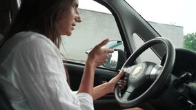 Happy woman talking on phone while driving in car on road Relaxed video call, professional conversation, female executive in automobile. business woman talking on video call on phone.