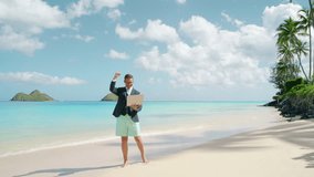 White male company employe in a suit and swim shorts having remote online meeting video call, felling happy and exited about closing his deal. Zoom call at the beach on a laptop during his vacation - Powered by Shutterstock - Get 15% off with code: PIKWIZARD15