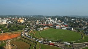 Drone view of Galle, Sri Lanka, showcasing urban landscape, historic cricket ground, cityscape, traffic, colonial architecture, clear skies, lush culture. Ideal for travel, tourism, urban development.