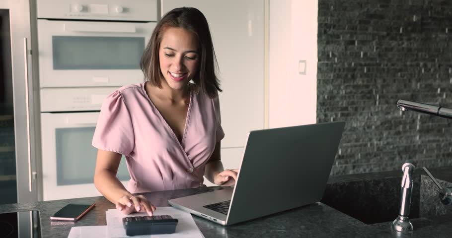 Satisfied with financial situation female calculates, pay through e-banking, make monthly payments feels happy and confident in tomorrow, having enough savings and good incomes to pay household bills Royalty-Free Stock Footage #3416435735