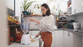 Woman, cooking and fruit in blender for smoothie, breakfast and happy with weight loss diet. Nutritionist, portrait or prepare healthy food, protein or vegetables in wellness drink mixture in kitchen - Powered by Shutterstock - Get 15% off with code: PIKWIZARD15