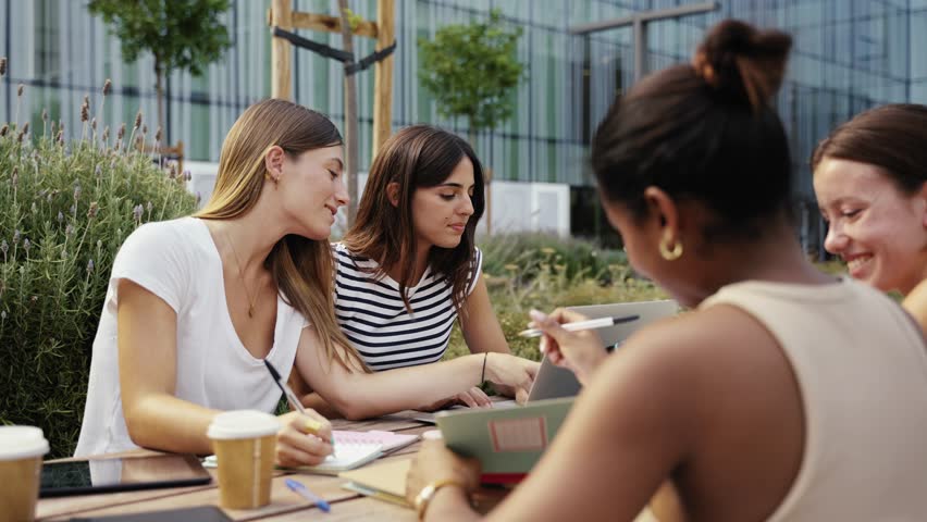 Young entrepreneur women freelancers team working on laptop the city