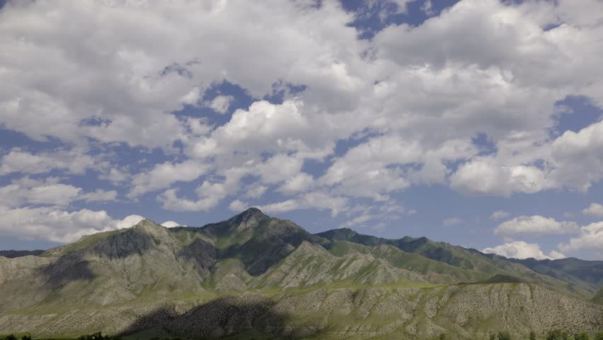 video with clouds mooving above rocks. majestic mountain landscape timelapse