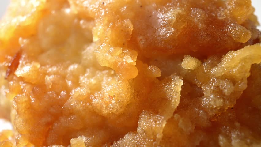 Close-up macro: In the world of fried chicken with extreme close-ups. Witness the sizzling, golden crust and tender, juicy meat in vivid detail. Fast food background. Food stock footage. 4K.
