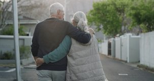 Old couple on walk in neighborhood together holding hands with hug, smile or love from back. Relax on retirement holiday, senior man and happy woman embrace in street for calm, healthy outdoor stroll - Powered by Shutterstock - Get 15% off with code: PIKWIZARD15