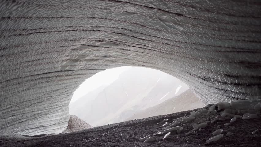 Rounded tunnel ice cave view from the inside. Cueva de Jimbo, Ushuaia, Tierra del Fuego