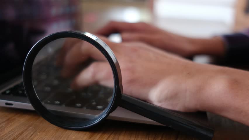 Magnifying glass padlock laptop security i person working with a laptop at his desk. Security, search, transaction, data, digital banking, artificial intelligence on the internet. Royalty-Free Stock Footage #3416712523