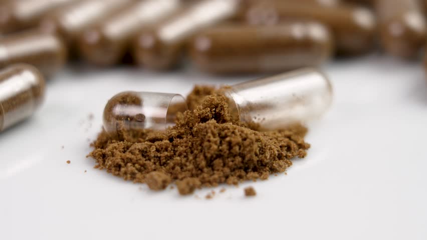 Nutrient supplement powder and brown herbal medicine capsules. Alternative medicine drug. Rotation