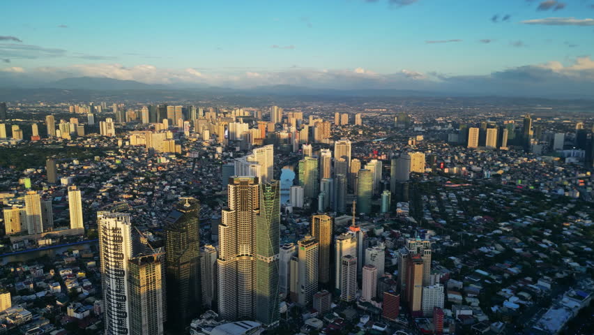 Aerial view of skyscrapers buildings in Makati business district and Manila city at sunset, capital of Philippines, panorama 4k