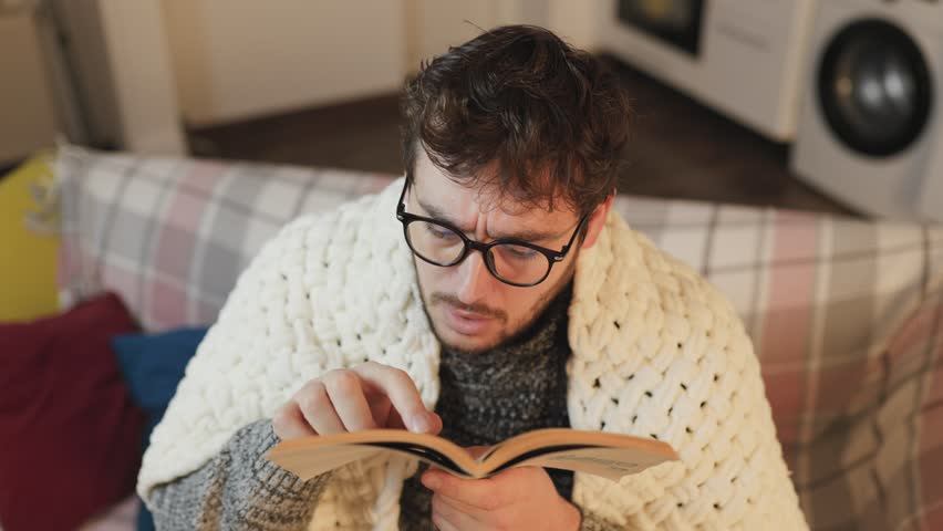 Amazed Reading Experience Male with Eyeglasses Captivated by Book, Wears an Expression of Wonder with Raised Finger, Immersed in the Marvels of the Written Word