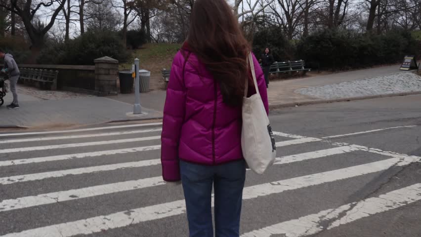 Wind blows in the hair of a young brunette woman