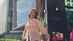 Portrait of Asian woman shopping goods outdoor in department store. Attractive young girl holding shopping bags then look at camera while walk with happiness enjoy purchasing in shopping mall center. - Powered by Shutterstock - Get 15% off with code: PIKWIZARD15