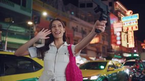 Asian young women vlogger use camera record vlog while travel in city. Attractive girl tourist feeling happy and relax, walking on street enjoy spend free leisure time for holiday vacation together.