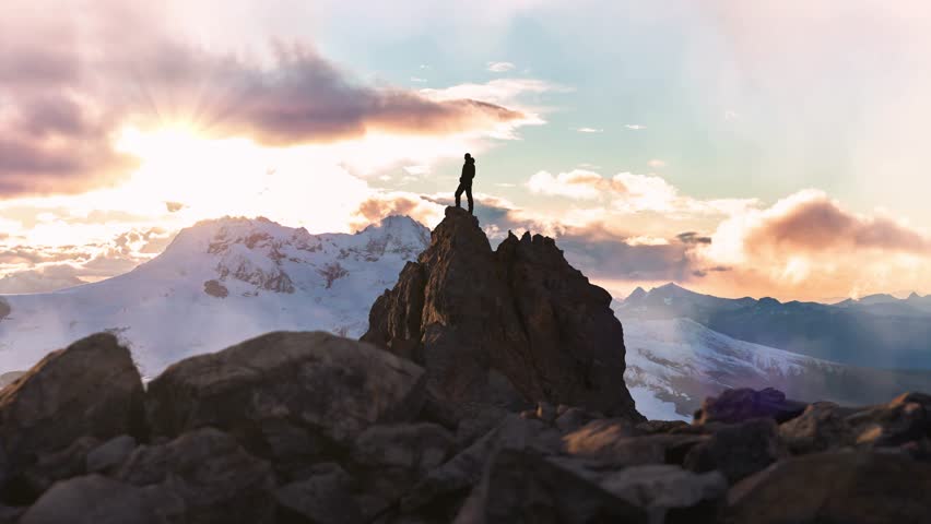 Adventure Man on top of Rocky Mountain Cliff. Aerial Canadian Mountain landscape from British Columbia in Background. 3d Rendering Peak.