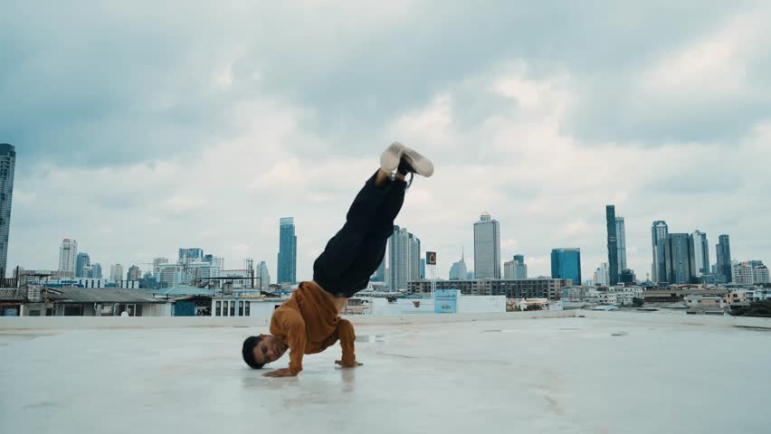 B-boy dance performance by street dancer at rooftop with sky scrapper, city view. Attractive asian hipster show energetic footstep. Break dancer practice street dance. Outdoor sport 2024. hiphop. Royalty-Free Stock Footage #3416920841