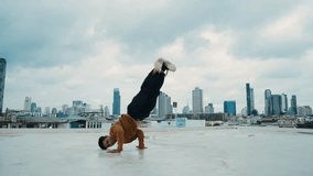 B-boy dance performance by street dancer at rooftop with sky scrapper, city view. Attractive asian hipster show energetic footstep. Break dancer practice street dance. Outdoor sport 2024. hiphop. - Powered by Shutterstock - Get 15% off with code: PIKWIZARD15