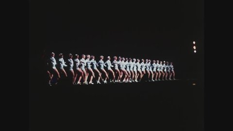 NEW YORK, 1971, Rockettes kicking high kicks at Radio City Music Hall, wide shot