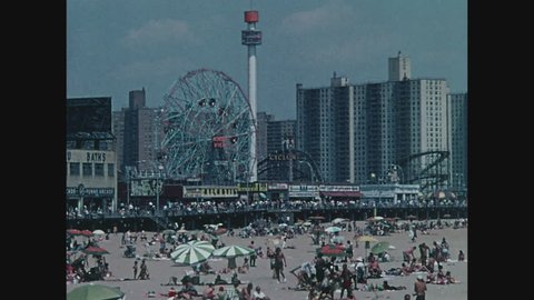 NEW YORK, 1971, Wide shot of beach, people and Ferris wheel at Coney Island, Brooklyn
