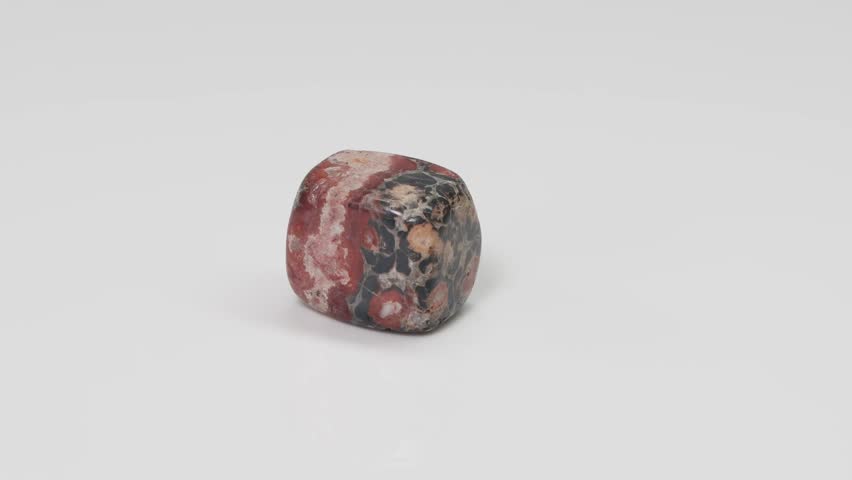 Leopard Skin Jasper stone rotating on white surface