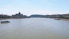 Video of beautiful cityscape in Budapest near Parliament and Danube river with turistic boat