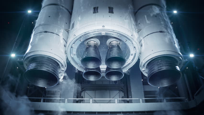 Space Exploration Rocket Launch at Night. Rocket Engine Ignition. Powerful and Hot Flames Burst out of the Nozzle after Initial Impulse. Vertical Takeoff of Large Space Rocket with Boosters.