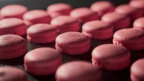Pink macaroons in electric oven. Process of cooking macarons. Delicious French dessert. Homemade macaroon cookies in oven. Baking concept. Close-up in 4K, UHD - Powered by Shutterstock - Get 15% off with code: PIKWIZARD15