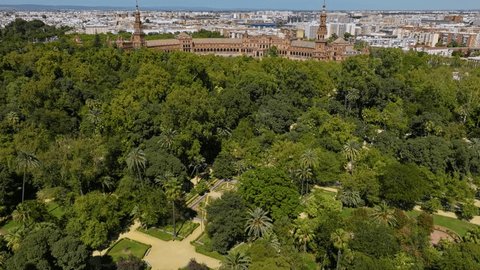 Flying Over The Parque de Maria Luisa To The Plaza de España In Seville, Spain. - aerial shot: film stockowy