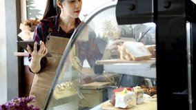 Asian professional retails small business owner female modern cafe bakery shop standing in front of counter holding technology tablet taking order from customer, barista waitress worker happy smiling - Powered by Shutterstock - Get 15% off with code: PIKWIZARD15