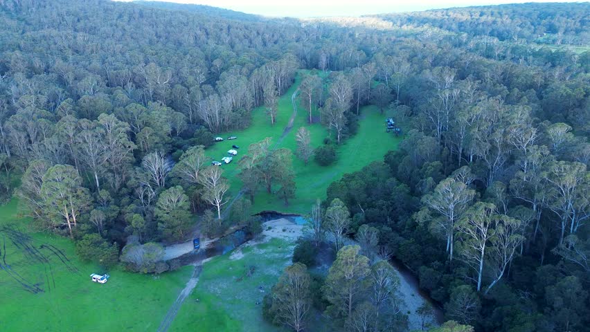 Drone aerial landscape of bushland campground forest property acreage trees tent travel tourism Eden Nethercote South Coast Australia Royalty-Free Stock Footage #3417212639