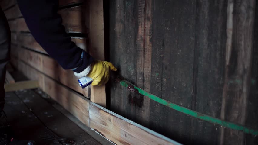 Man Sprays Grease To Lubricate Rusty Nuts And Bolts Before Removing Inside Barn. closeup shot