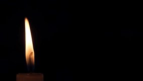 close-up candle flame sways in the dark in the wind. copyspace on the right. - Powered by Shutterstock - Get 15% off with code: PIKWIZARD15