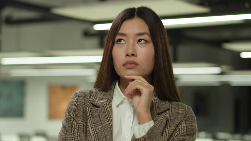 Asian girl in office Korean business woman lady Chinese businesswoman Japanese female manager worker student indoors confused pensive think thoughtful thinking puzzled solving challenge idea solution Royalty-Free Stock Footage #3417250697