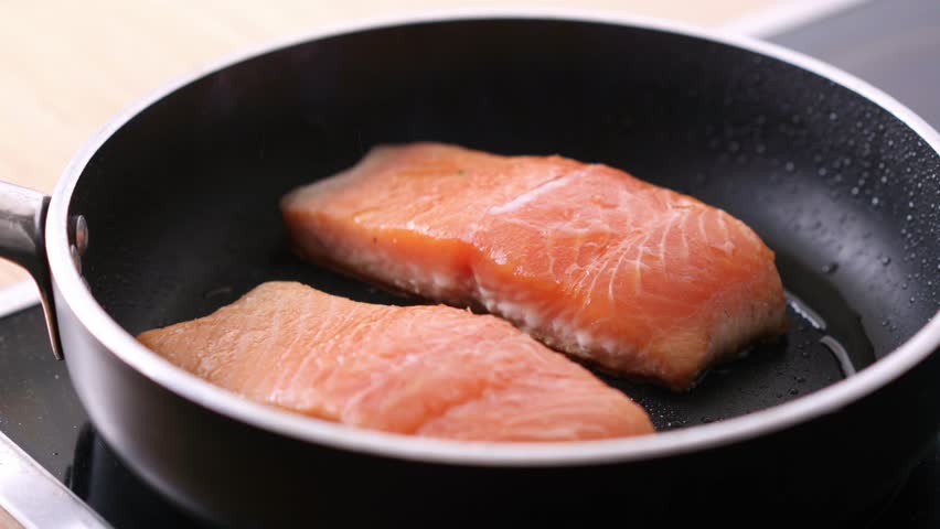 Pan-fried Salmon. Cooking salmon in a pan. High quality 4k footage