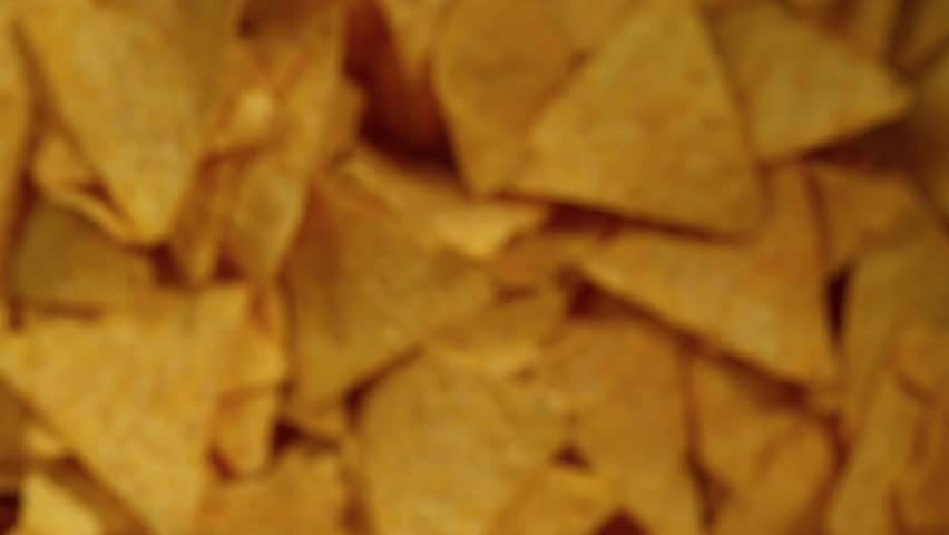 Super slow motion of flying tortilla chips on black background. Filmed on high speed cinema camera, 1000 fps. Speed ramp effect. Royalty-Free Stock Footage #3417316327