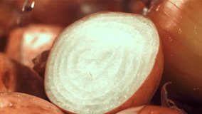Water drips onto the cut half of the onion. Filmed on a high-speed camera at 1000 fps. High quality FullHD footage