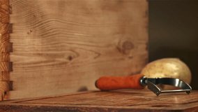Potatoes fall on a wooden board. Filmed on a high-speed camera at 1000 fps. High quality FullHD footage
