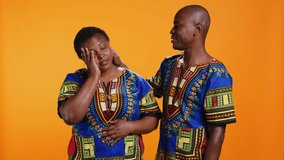 Tired husband and wife dealing with migraine on camera, being in pain and rubbing temples to ease tension. African american married couple feeling sick with painful headache, overworked. - Powered by Shutterstock - Get 15% off with code: PIKWIZARD15