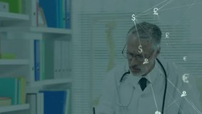 Animation of network of economy icons over caucasian male doctor at desk. Medical services, healthcare, digital interface, finance, networks and global communication, digitally generated video. - Powered by Shutterstock - Get 15% off with code: PIKWIZARD15