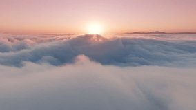 Epic aerial view over paradise cloudscape at sunrise or sunset. Wonderful inspirational sky with gentle pastel pink, peach and light blue clouds swirling fast below. Time lapse above beautiful clouds - Powered by Shutterstock - Get 15% off with code: PIKWIZARD15