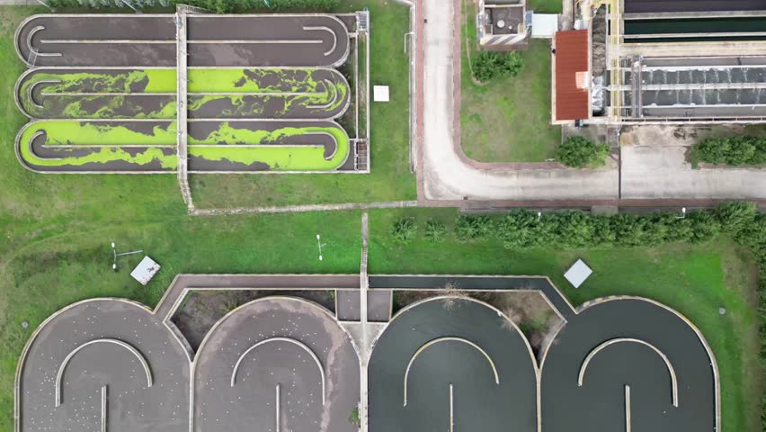 Aerial timelapse of a wastewater treatment plant in working. Birds are searching for food. Royalty-Free Stock Footage #3417704343