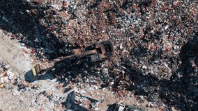 Damage Pollution Concept of Ecosystem Land. Big Waste Dump and Trash Truck with Garbage in Aerial Top View. Large Rubbish Landfill with Heaps Dirt Refuse. Factory with Bulldozer Machine and Workers 4k - Powered by Shutterstock - Get 15% off with code: PIKWIZARD15