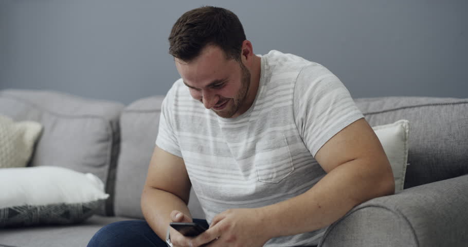 Infidelity, couple and caught cheating on phone with fight, conflict or argument about social media. Divorce, breakup or affair with man and woman on sofa in home living room for online communication