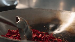 Sizzling Sichuan Delight: Close-Up of Red Peppers Stir-Frying in Wok - Powered by Shutterstock - Get 15% off with code: PIKWIZARD15