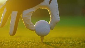 Golfer placing golf ball on the tee at golf course. Close up. People, sport, leisure activity, recreation and lifestyle - Powered by Shutterstock - Get 15% off with code: PIKWIZARD15