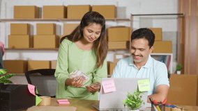 happy businesswoman counting money at ecommerce warehouse while with coworker - concept of successful profit or earnings, entrepreneurship and banking or financial - Powered by Shutterstock - Get 15% off with code: PIKWIZARD15
