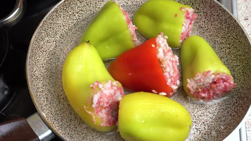 Preparing stuffed peppers. Stuffed peppers are cooked in a frying pan. Step-by-step cooking video recipe. Cooking master class. Royalty-Free Stock Footage #3417935085