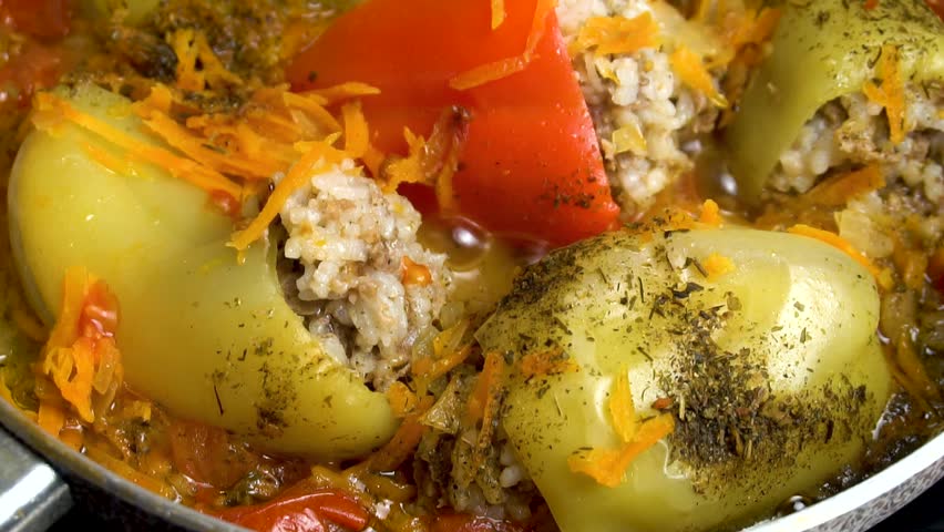 Preparing stuffed peppers - stuffed peppers are cooked in a frying pan, extreme close-up. Step-by-step cooking video recipe. Culinary master class. Royalty-Free Stock Footage #3417942451